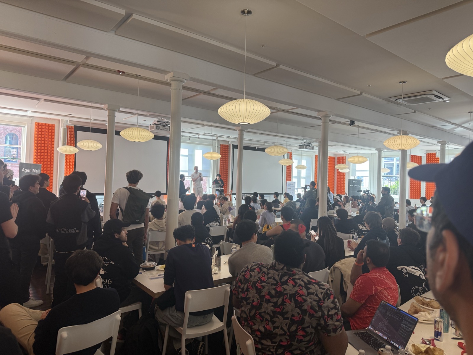 Large AI event room with audience and keynote speaker